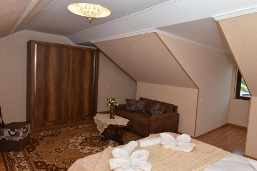 a room with two beds and a couch in it at Light House Old City in Akhaltsikhe