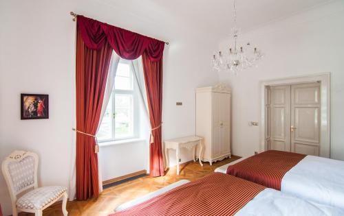 a bedroom with a bed and a window at Zámek Jeseník Nad Odrou in Jeseník nad Odrou