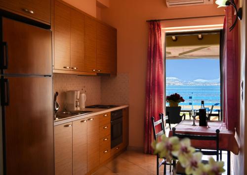 a kitchen with a table and a view of the ocean at Akrogiali in Myloi