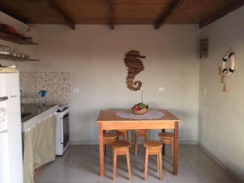 a kitchen with a table and two stools in a room at Casa Pitaya in Corumbau