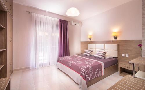 a bedroom with a large bed and a window at Tsamakdas House in Toroni