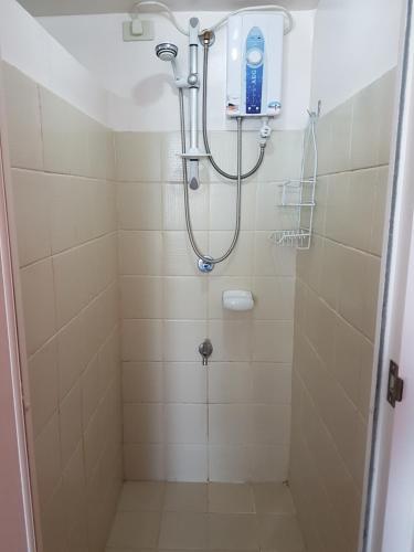 a shower with a shower head in a bathroom at Tagaytay Modern Minimalistic Condo in Tagaytay