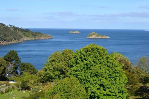 two islands in a body of water with trees at The Headland Hotel & Spa in Torquay