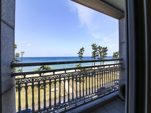 a view of the beach from a balcony at Gyeongpo Soo Hotel in Gangneung