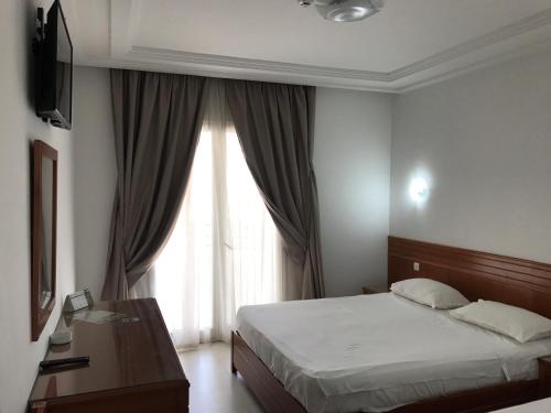 Postel nebo postele na pokoji v ubytování Hotel AL KARMEL