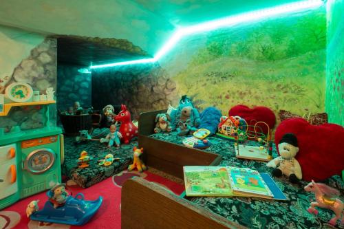 a room filled with toys and a bed with a painting at Altachhof Hotel und Ferienanlage - Jokercard im Sommer inklusive in Saalbach Hinterglemm
