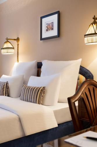 a living room with a couch and pillows at Hotel Barsey by Warwick in Brussels