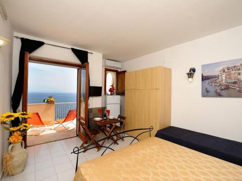 a bedroom with a bed and a view of the ocean at Amalfi Super Panoramico in Amalfi