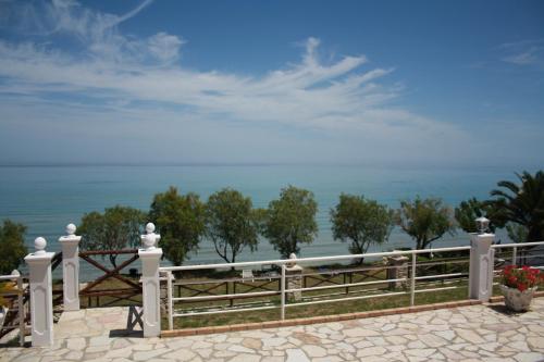 a white fence with a view of the ocean at Laura Beach House in Alykes