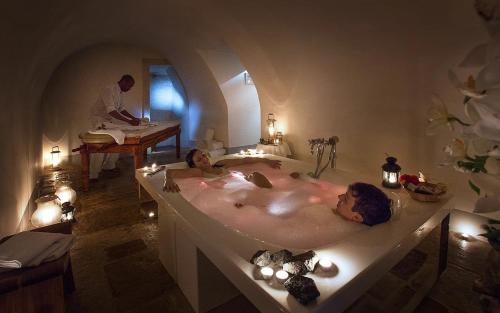 two people in a bath tub in a bathroom at Relais & Chateaux Palazzo Seneca in Norcia