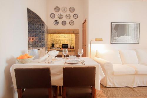 ein Wohnzimmer mit einem Tisch und einem weißen Sofa in der Unterkunft Traditional Studio in Alfama in Lissabon