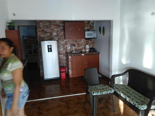 a young man walking through a living room at Casa Madrigueña in Rincón