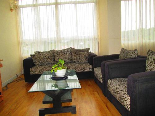 a living room with a couch and a coffee table at Kandyan Sweet Villa in Kandy