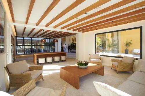 a living room with a table and chairs at Club del Sol Aparthotel in Port de Pollensa