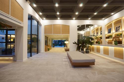 a lobby with a bench in the middle of a building at Club del Sol Aparthotel in Port de Pollensa