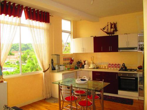 a kitchen with a table and chairs and a window at Kandyan Sweet Villa in Kandy