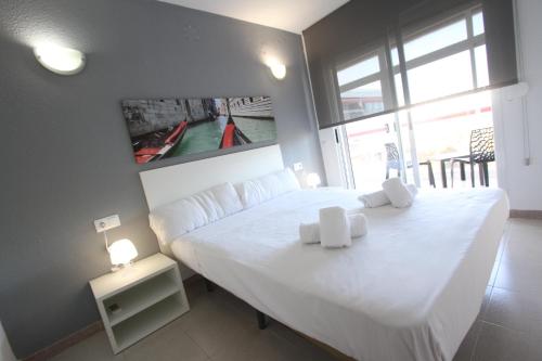 サロウにあるFor a Stay Varaderoのベッドルーム1室(白い大型ベッド1台、白いタオル2枚付)
