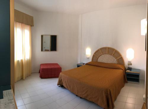 a bedroom with a bed and a dresser at Hotel Palme in Monterosso al Mare