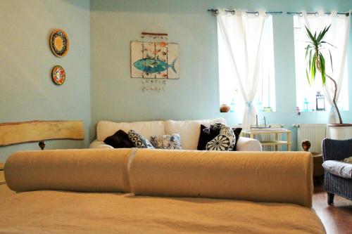 a living room with a couch with pillows on it at Best view small house free parking self check-in in Budapest