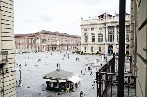 a group of people walking around a city plaza at Piazza Castello Suite in Turin