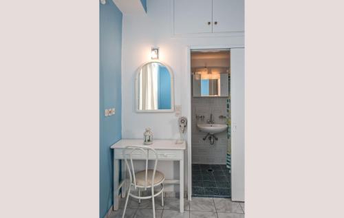 a bathroom with a sink and a vanity with a mirror at Prasino Oniro in Tinos Town