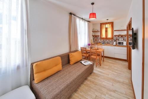 a living room with a couch and a kitchen at Mare Nostrum in Kas