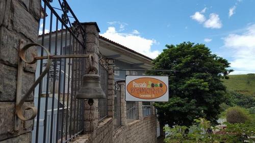a bell hanging on the side of a building at Pousada D'amoras in Conservatória