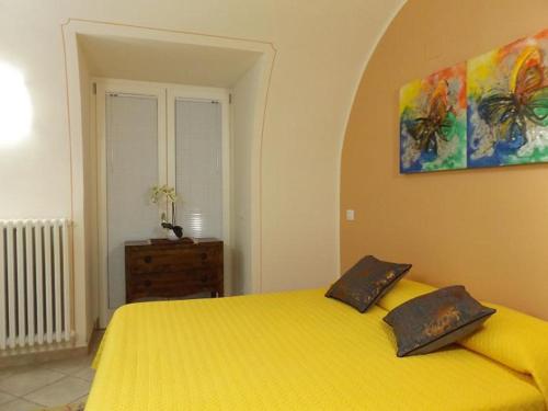 トッリ・デル・ベーナコにあるCasa Porticiのベッドルーム1室(黄色のベッド1台、枕2つ付)
