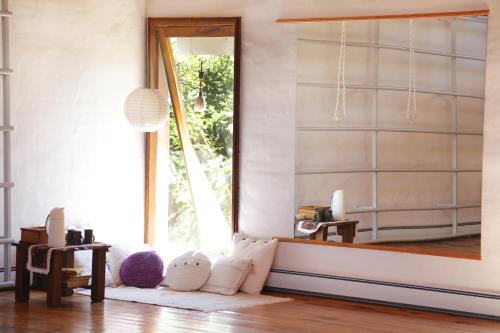 a living room with a large window and a mirror at Las Dalias in Villa Las Rosas