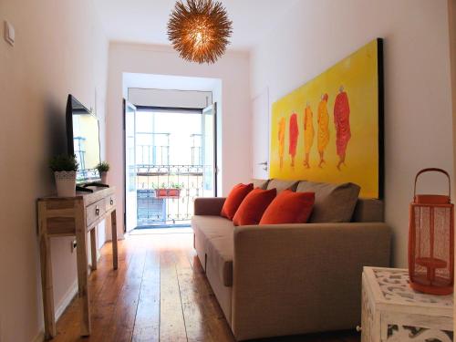 a living room with a couch and a painting on the wall at BairroSweethome in Lisbon