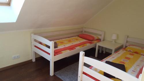 a small room with two bunk beds and a table at Reimani Holiday House in Vanaveski