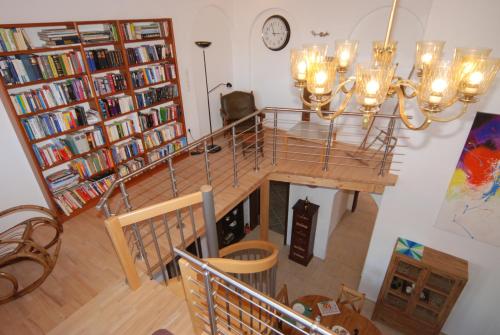 an overhead view of a dining room with a chandelier at Haus über den Dächern von Heiligenhafen in Heiligenhafen