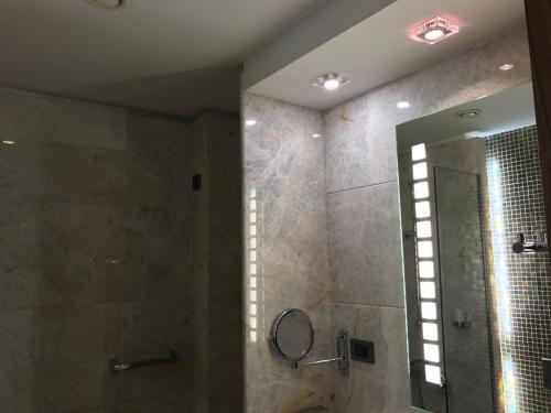 a bathroom with a shower and a mirror at Hotel Levadia in Levádeia