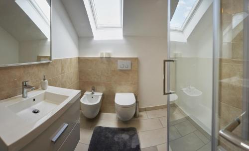 a bathroom with a sink and a toilet and a shower at Apartment Ivana B in Lesce