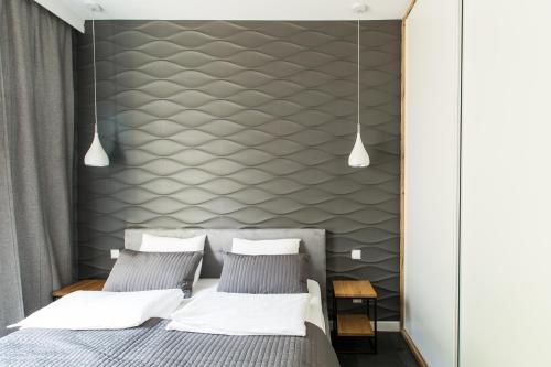 Een bed of bedden in een kamer bij Homewell Apartments Maraton Gardens
