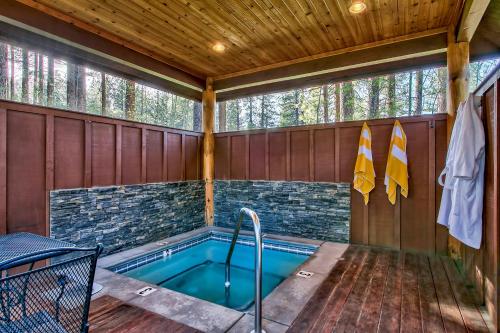 a swimming pool in a wooden house with a wooden ceiling at Black Bear Lodge in South Lake Tahoe