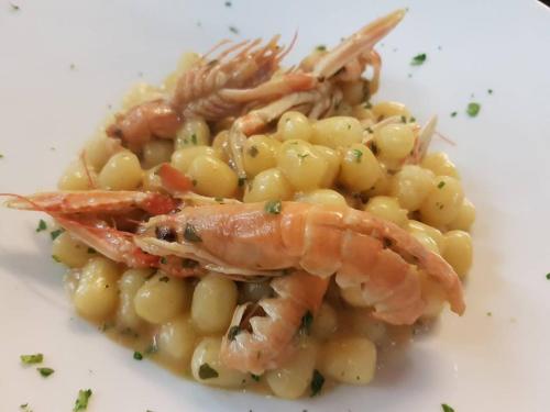 a plate of food with shrimp on a pasta dish at Villa Grazia in Viareggio