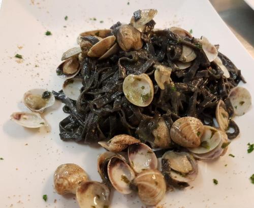 a pile of mushrooms on a white plate at Villa Grazia in Viareggio