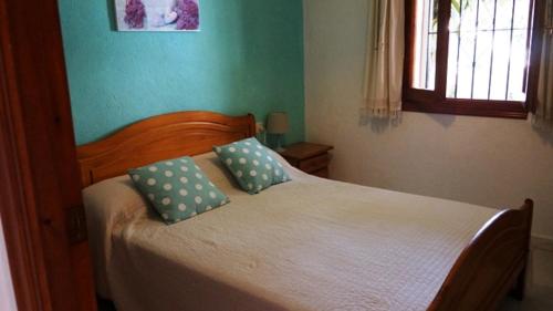 a bedroom with a bed with two pillows on it at Patio Andaluz in Denia