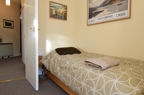 a bedroom with a bed and a picture on the wall at Mansfield Apartment in Hawick