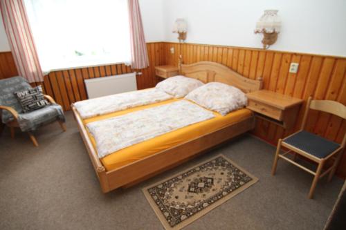 a bedroom with a bed and a desk and a chair at Chata Javorina in Javorník