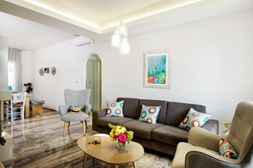 a living room with a couch and a table at Beachside Apartment in Plakias centre! in Plakias