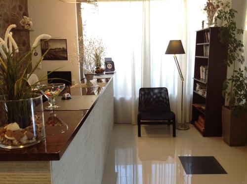 a living room with a counter and a chair at Angela Hotel in Agia Marina Aegina