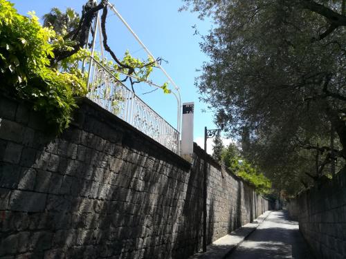 a brick wall with a fence on top of it at Muta House in Sorrento