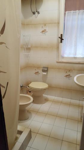 a bathroom with a toilet and a sink at Casa Tina in Pomonte
