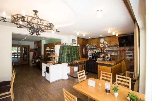 a restaurant with wooden tables and chairs and a counter at Ferienhof Alte Post, Apartments in Weissbriach