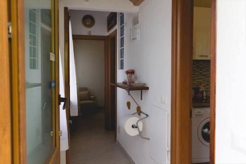 a hallway leading to a laundry room with a washing machine at Borgo Foce La Spezia in La Foce
