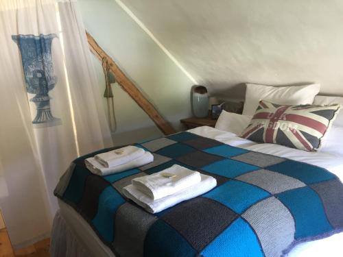 a bedroom with a bed with towels on it at All Seasons Bed & Breakfast in Kerpen