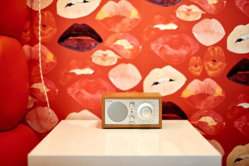 a small radio sitting on a table in front of a wall at Austin Motel in Austin