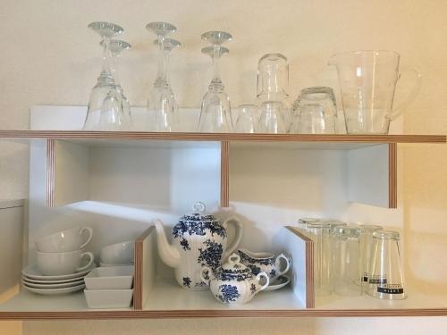 a shelf filled with glasses and other glass items at Landhausvilla Strittberg 7 in Höchenschwand